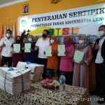 Warga yang menerima sertipikat PTSL berfoto bersama Kakantah Kabupaten Bandung,Julianto beserta jajarannya